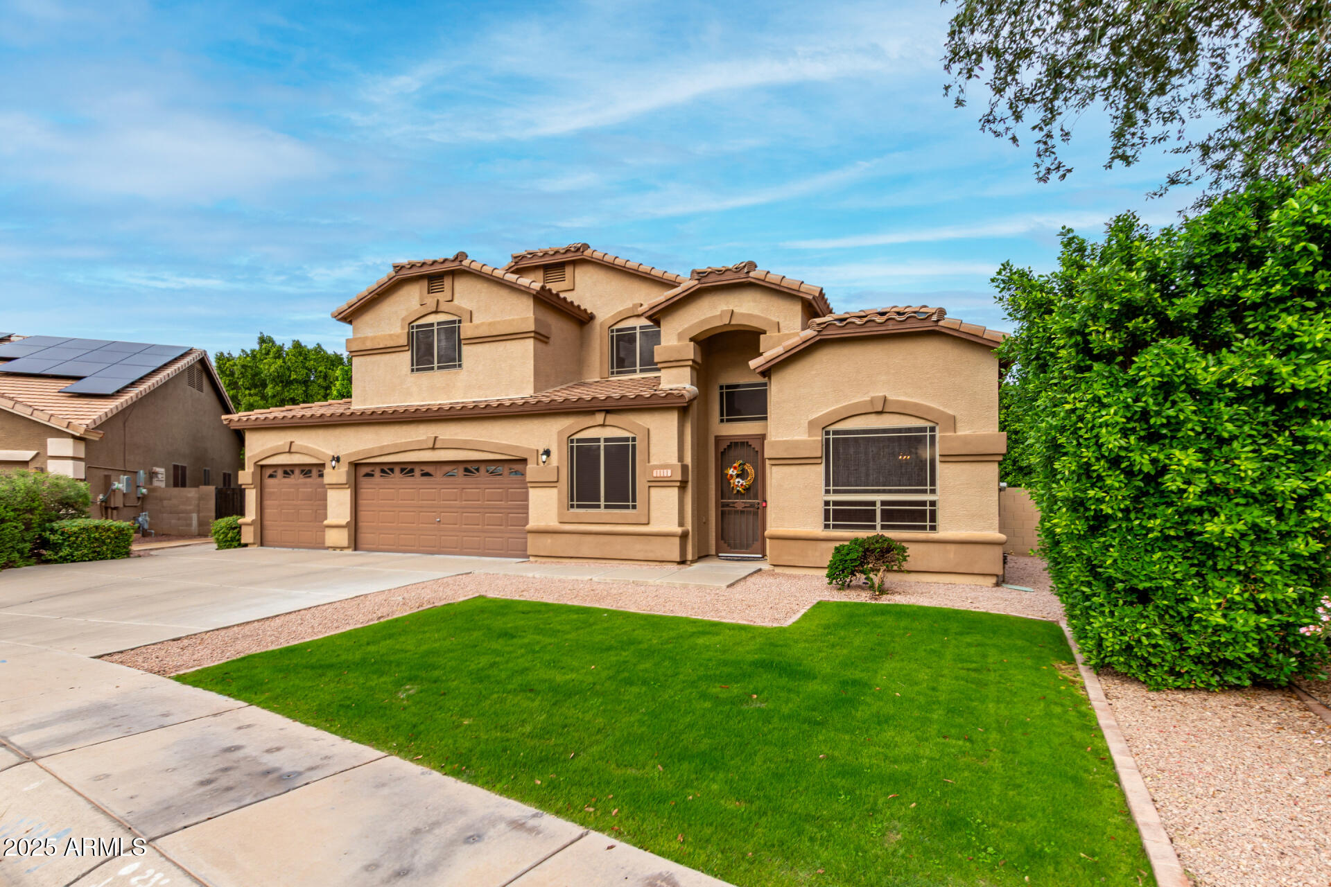 1111 South Sandstone Street Gilbert, AZ 85296 - Photo 4 of 59 a front view of a house with a yard and trees