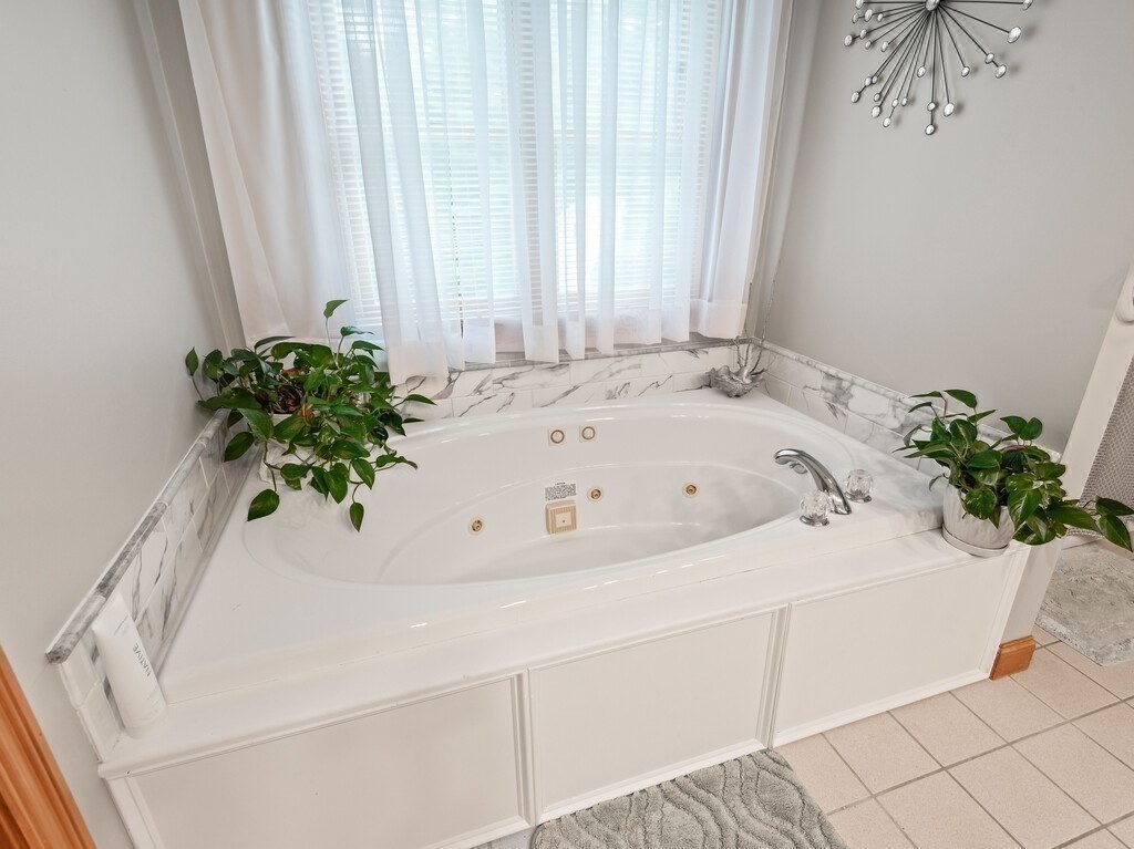 9 Santom Street Auburn, MA 01501 - Photo 20 of 42 a white bath tub sitting in a bathroom