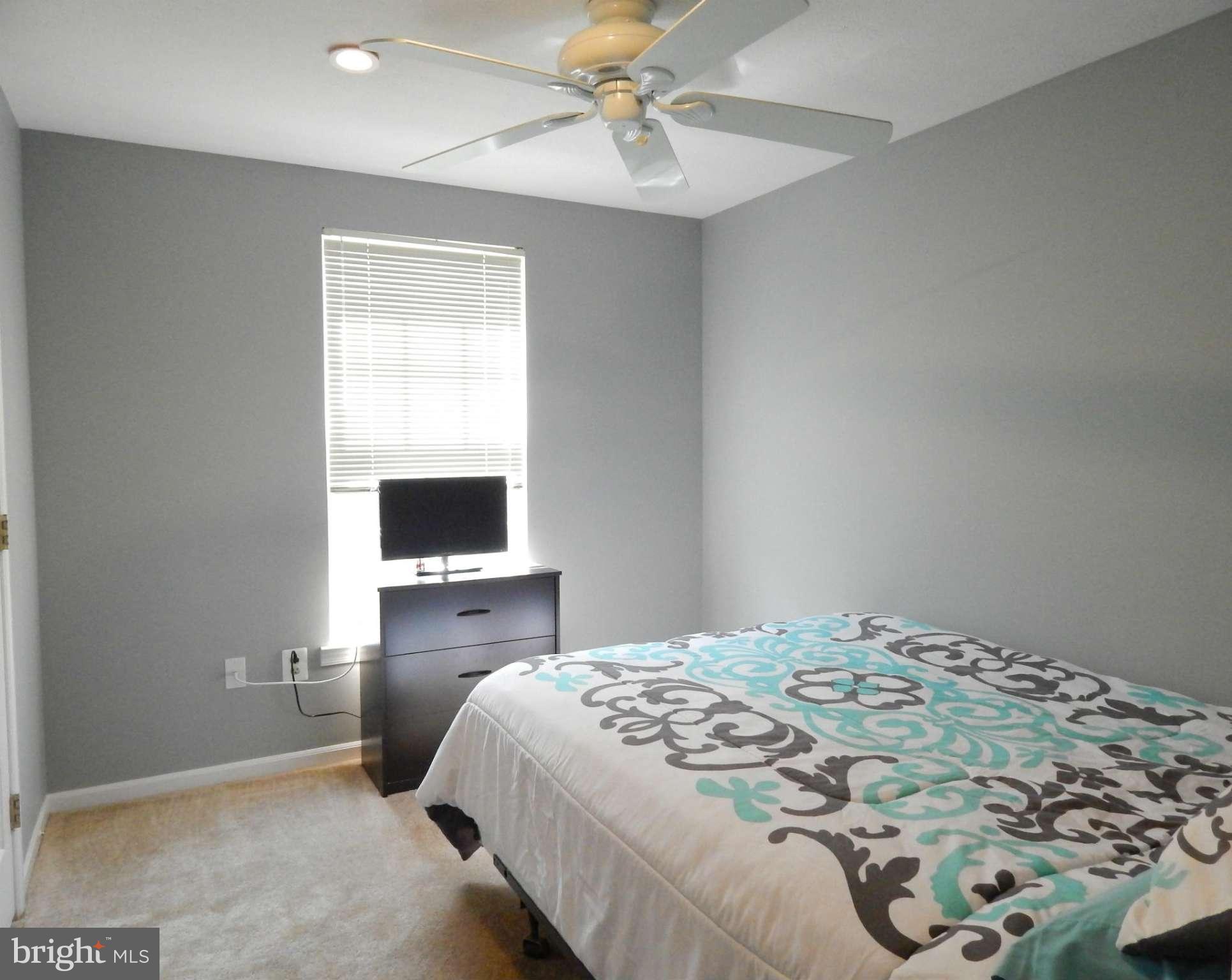 7799 Paddock Way Baltimore, MD 21244 - Photo 14 of 27 a bedroom with a bed and a chandelier