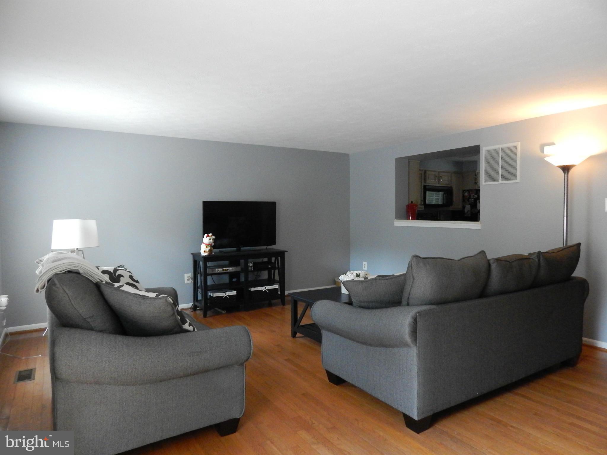 7799 Paddock Way Baltimore, MD 21244 - Photo 16 of 27 a living room with furniture and a flat screen tv