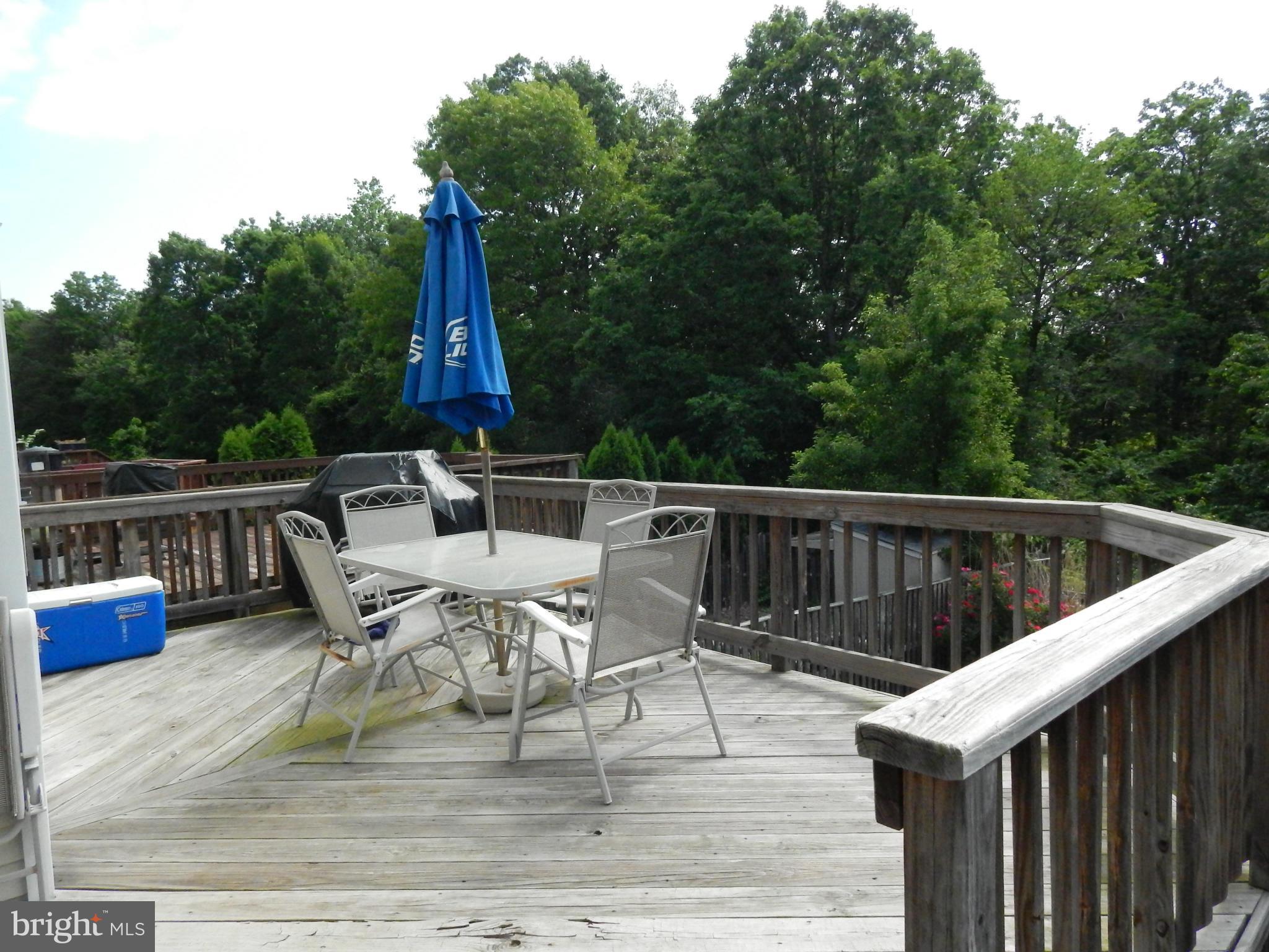 7799 Paddock Way Baltimore, MD 21244 - Photo 19 of 27 a view of deck with furniture and trees