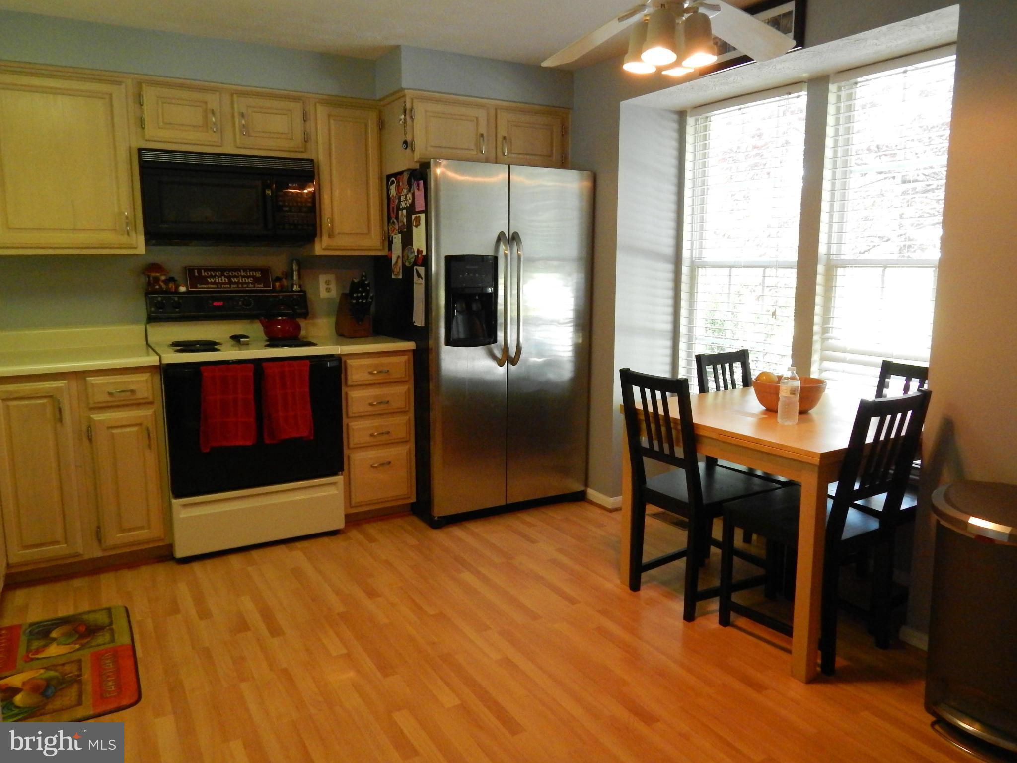 7799 Paddock Way Baltimore, MD 21244 - Photo 20 of 27 a kitchen with stainless steel appliances a stove a sink and a refrigerator
