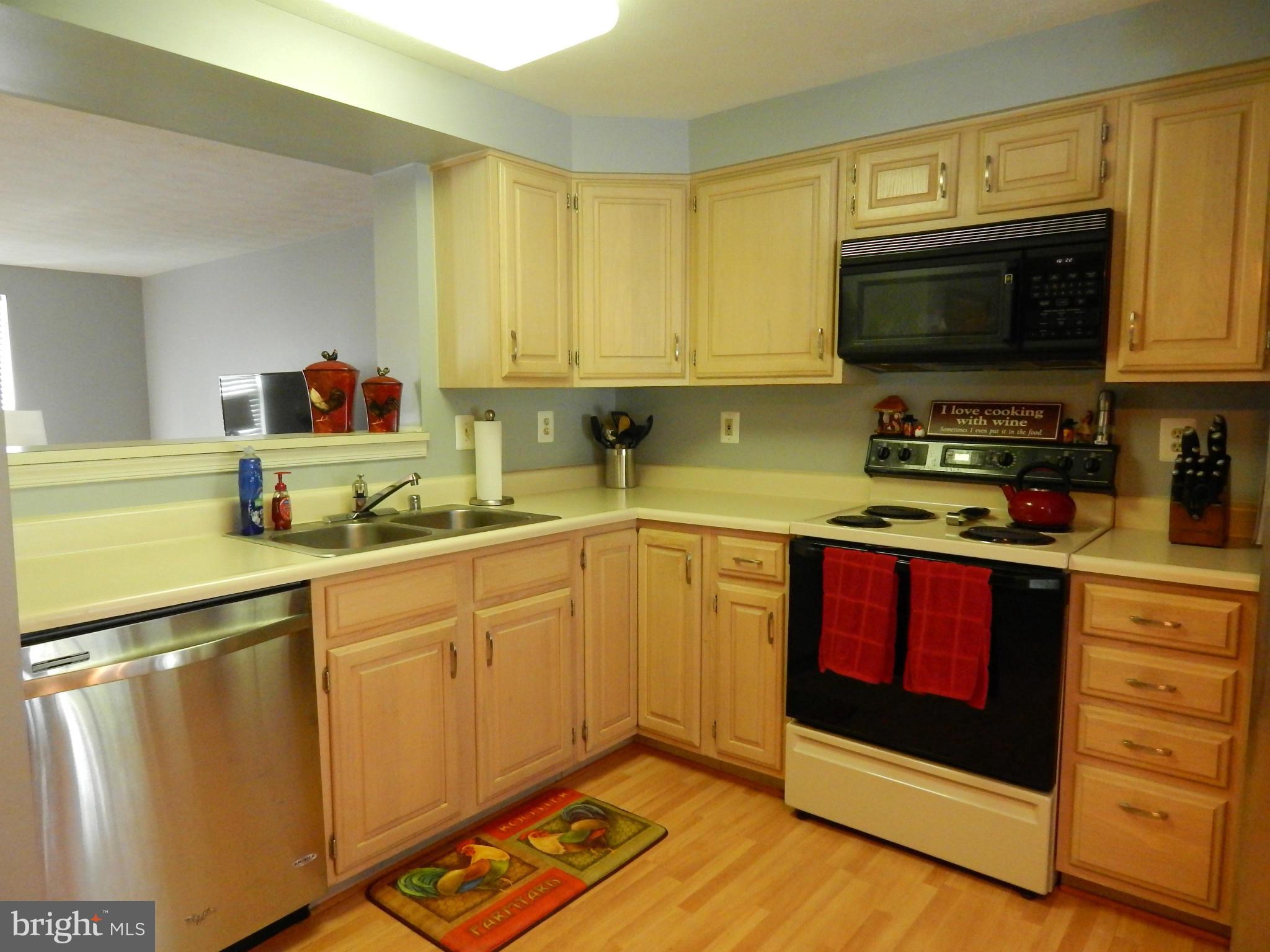 7799 Paddock Way Baltimore, MD 21244 - Photo 21 of 27 a kitchen with stainless steel appliances white cabinets and a stove top oven