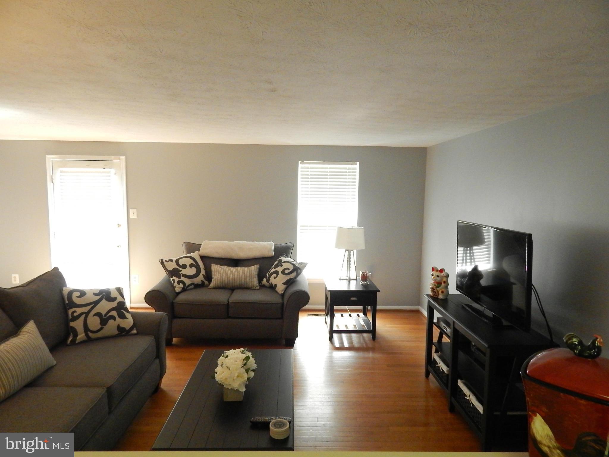 7799 Paddock Way Baltimore, MD 21244 - Photo 22 of 27 a living room with furniture and a flat screen tv
