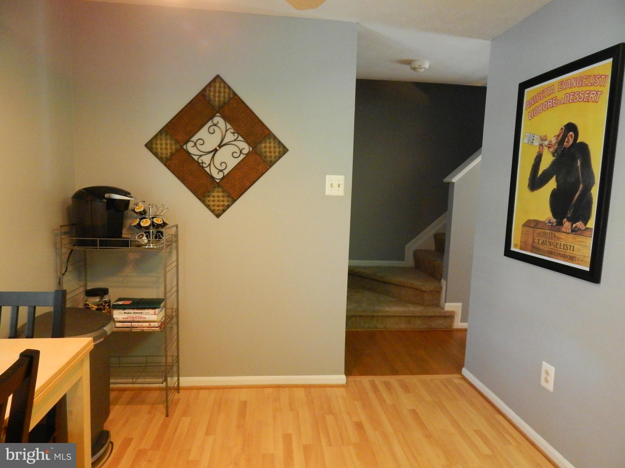 7799 Paddock Way Baltimore, MD 21244 - Photo 24 of 27 a view of a hallway with paintings on the wall