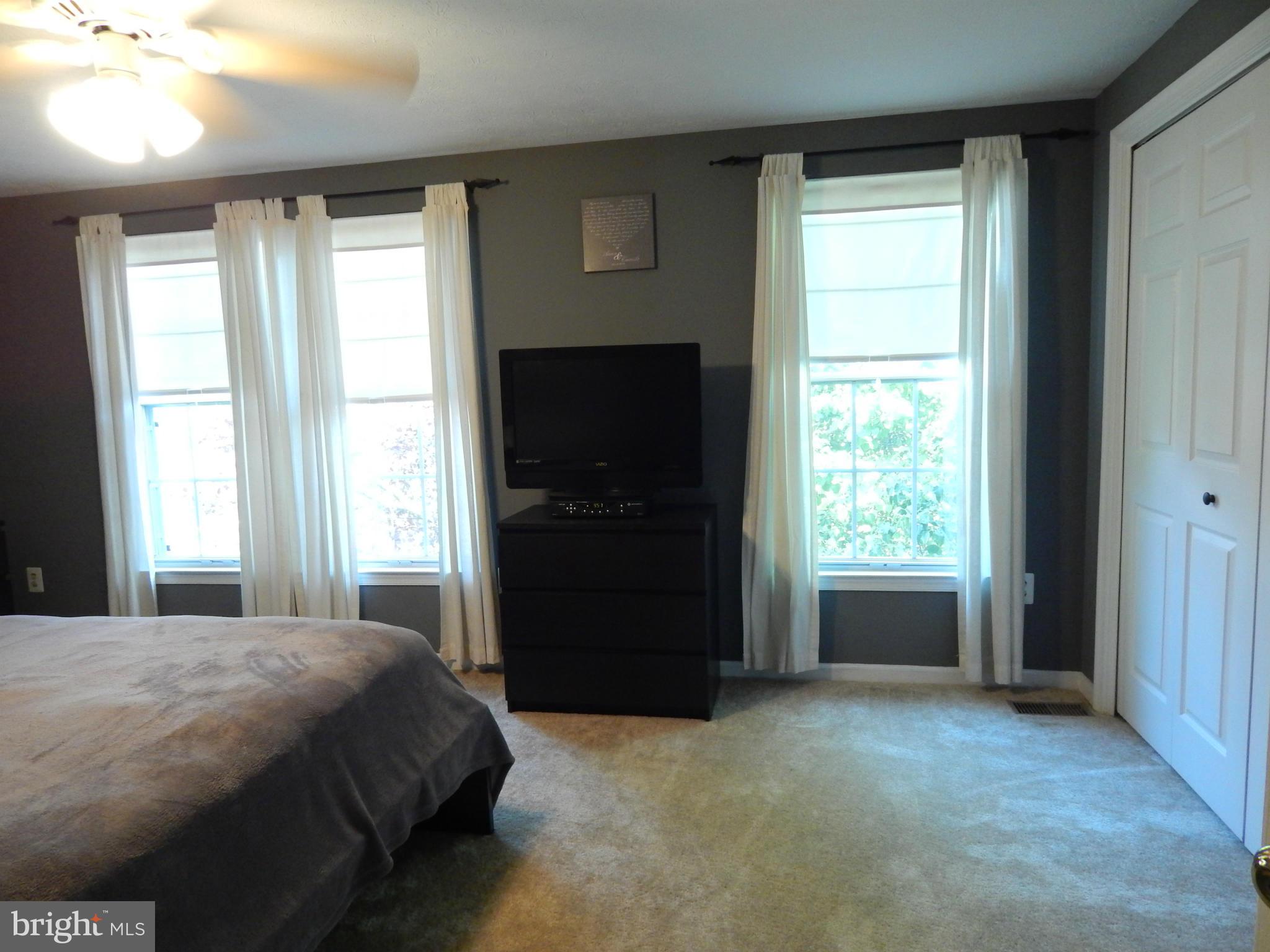 7799 Paddock Way Baltimore, MD 21244 - Photo 7 of 27 a spacious bedroom with a bed and a window