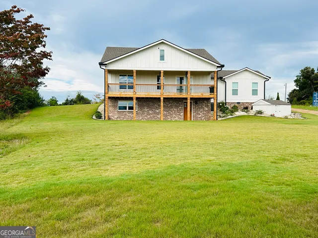 a view of a house with a swimming pool and a yard