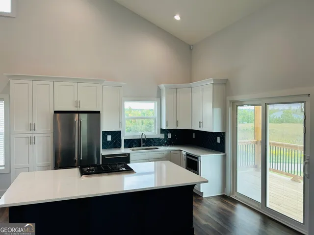 a kitchen with a refrigerator and a sink