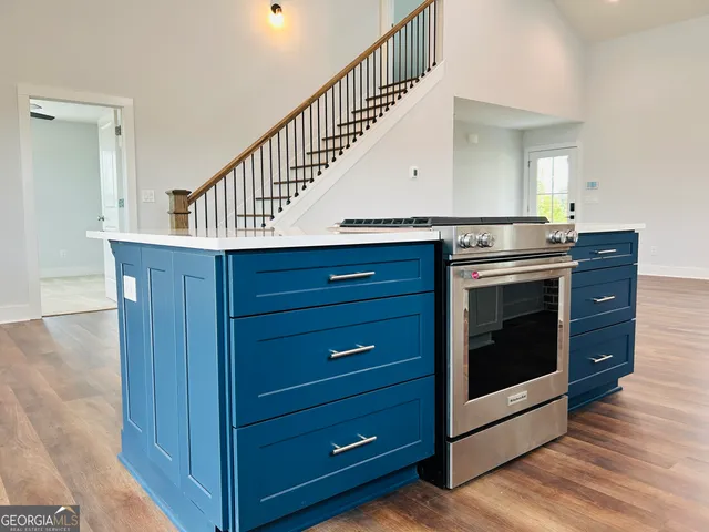 a kitchen with wooden cabinets and a stove top oven