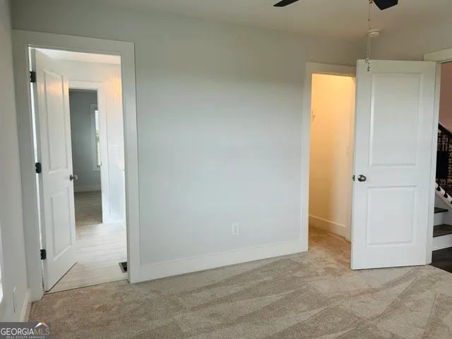 an empty room with windows and closet