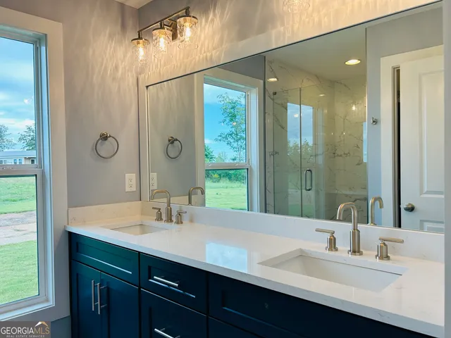 a bathroom with a shower a toilet and a sink
