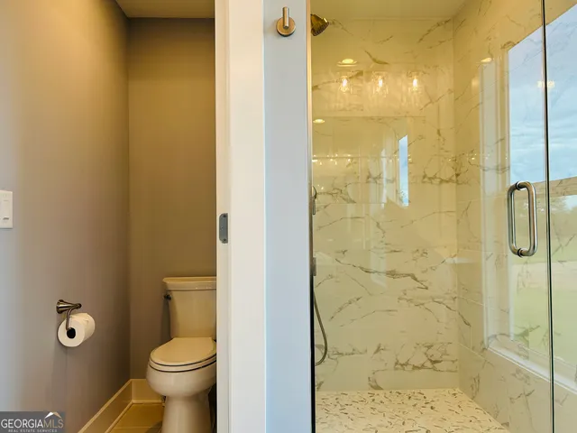 a view of a livingroom with a ceiling fan and window