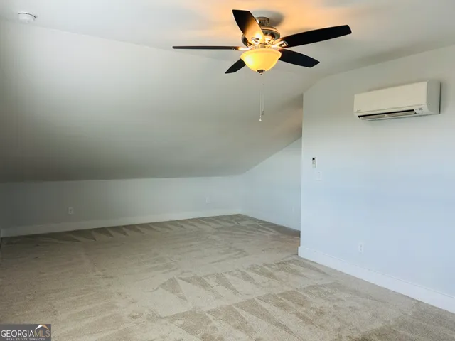 a view of room with a ceiling fan and window