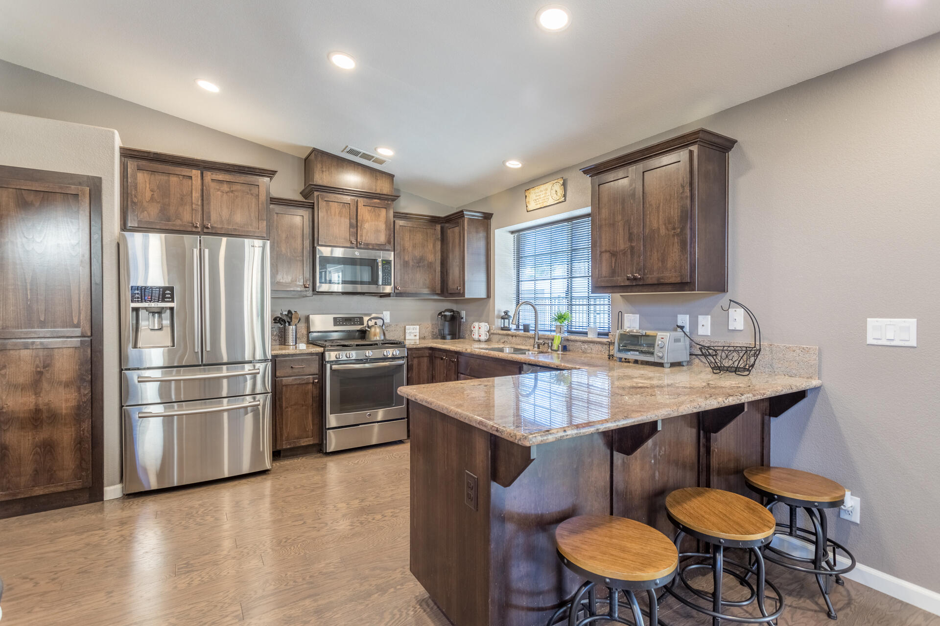 6582 Hemlock Street Redding, CA 96001 - Photo 11 of 35 a kitchen with stainless steel appliances granite countertop a sink stove and refrigerator
