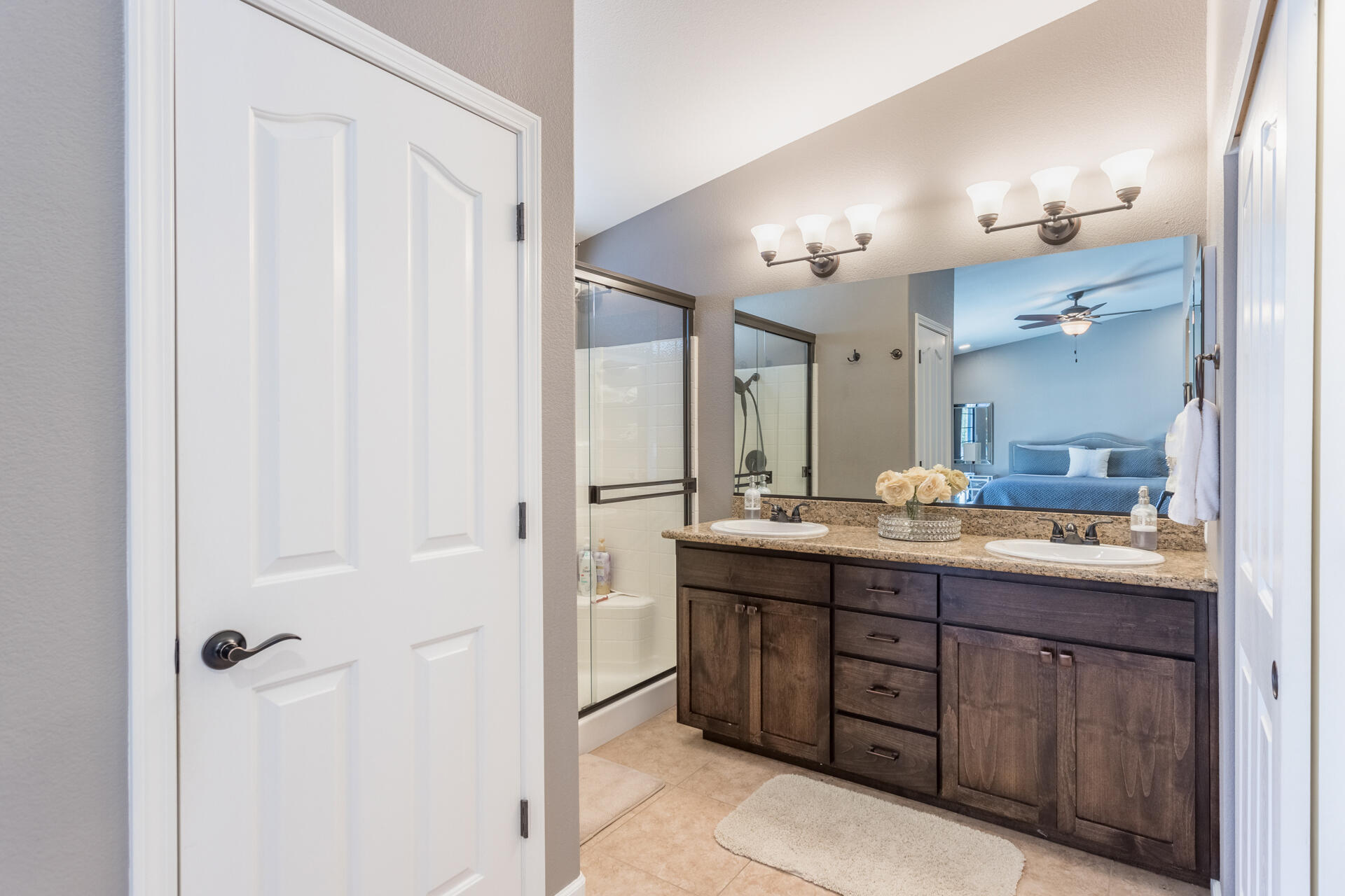 6582 Hemlock Street Redding, CA 96001 - Photo 15 of 35 a bathroom with a granite countertop sink a mirror and a shower