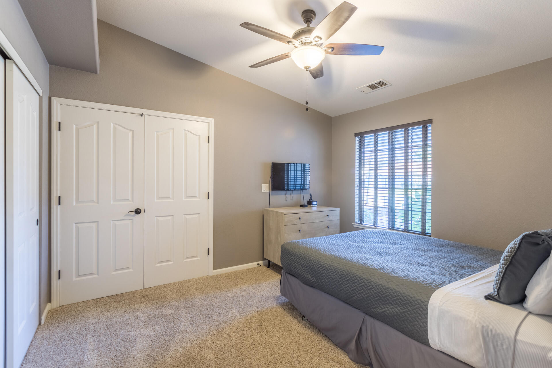 6582 Hemlock Street Redding, CA 96001 - Photo 17 of 35 a large bedroom with a bed and a chandelier