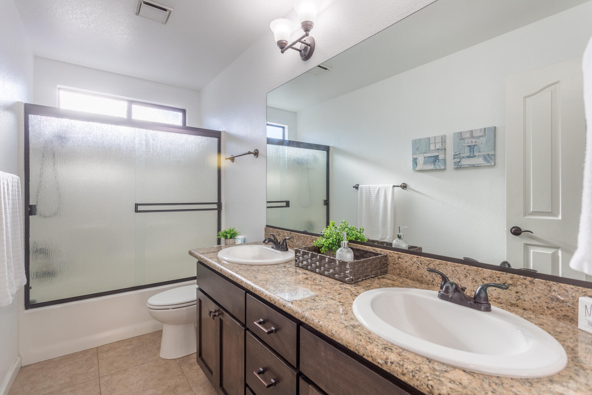 6582 Hemlock Street Redding, CA 96001 - Photo 19 of 35 a bathroom with a granite countertop sink a toilet and a large mirror