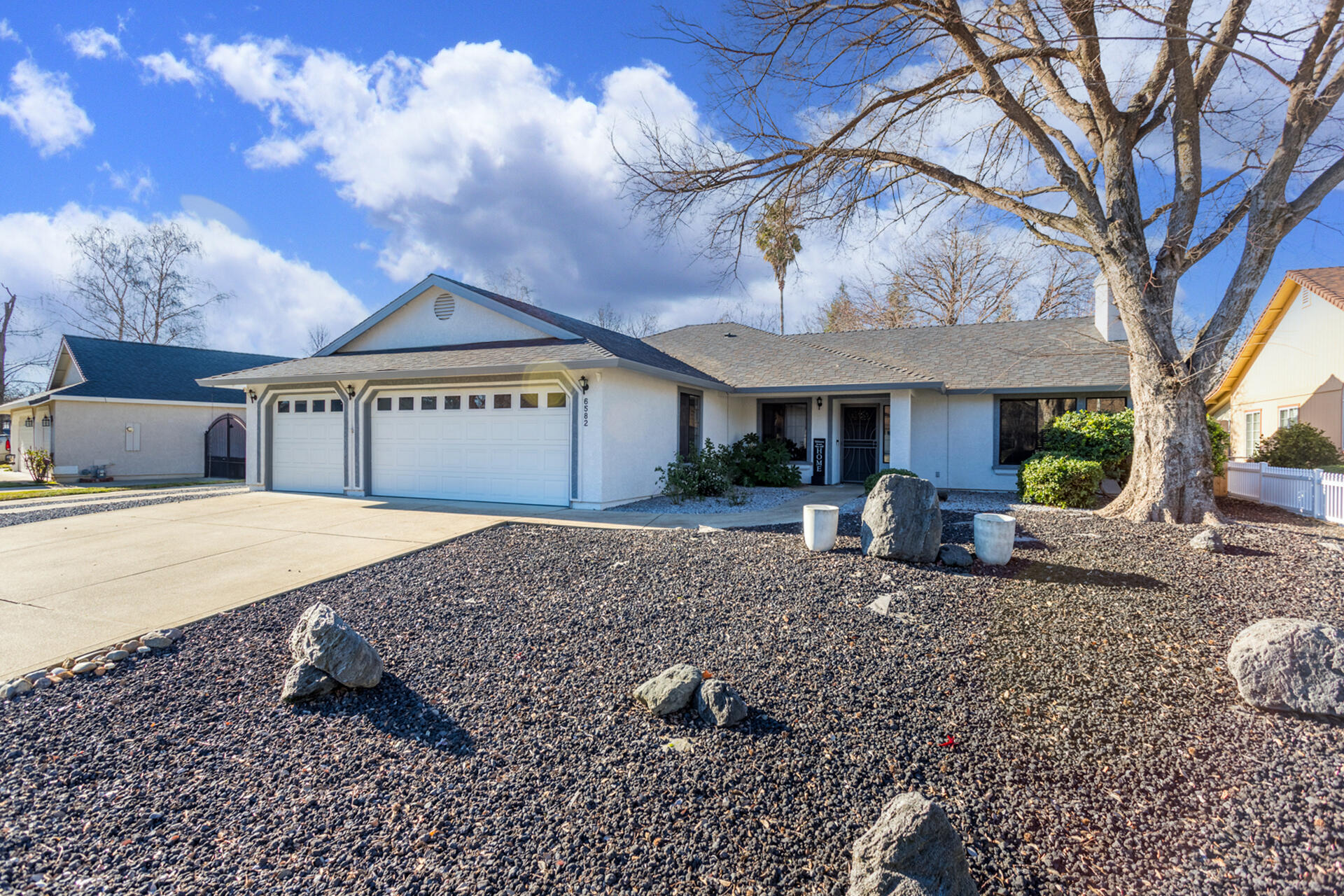 6582 Hemlock Street Redding, CA 96001 - Photo 2 of 35 a view of a house with a yard and wooden fence