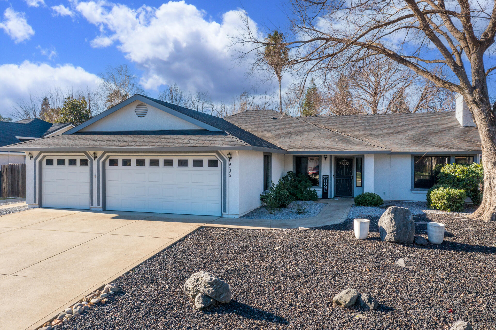 6582 Hemlock Street Redding, CA 96001 - Photo 31 of 35 a front view of a house with a yard and garage