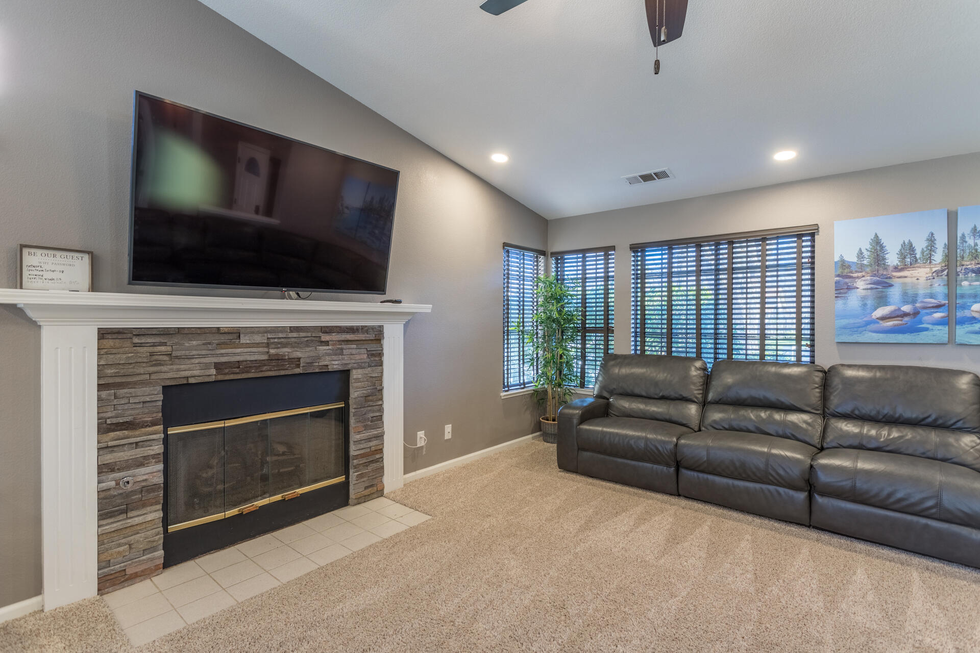 6582 Hemlock Street Redding, CA 96001 - Photo 7 of 35 a living room with furniture a flat screen tv and a fireplace