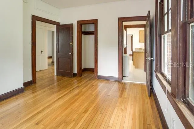 a view of a room with wooden floor and door