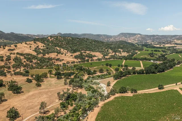 aerial view of a house with a lake view