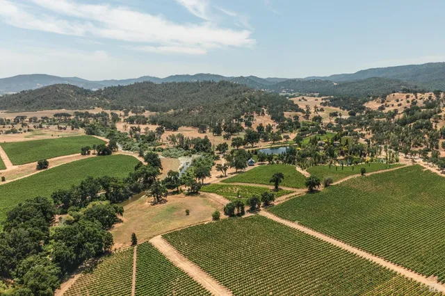 an aerial view of a house with a lake view