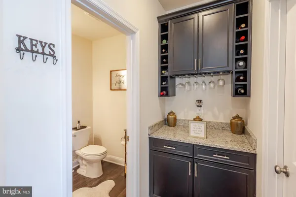a spacious bathroom with a granite countertop sink and a toilet