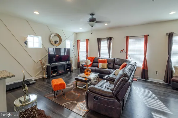 a living room with furniture a rug and a window