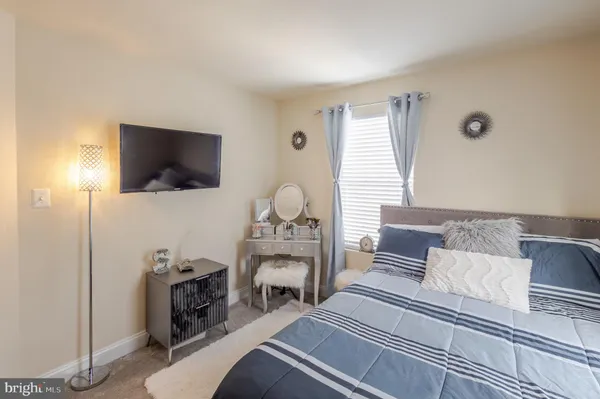 a bedroom with furniture and a flat screen tv