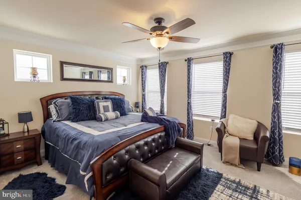 a bedroom with a bed couch and window