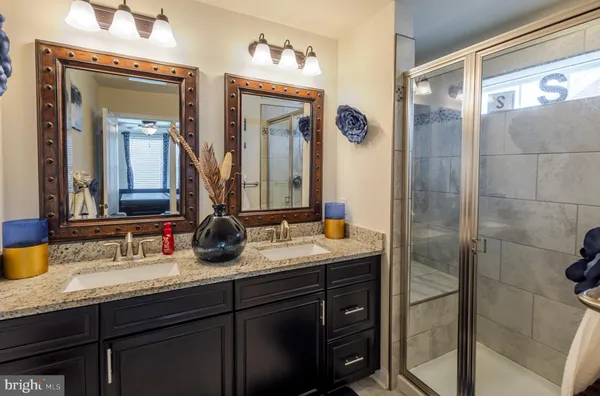 a bathroom with a granite countertop sink and a mirror