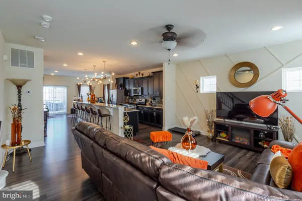 a living room with furniture and kitchen view