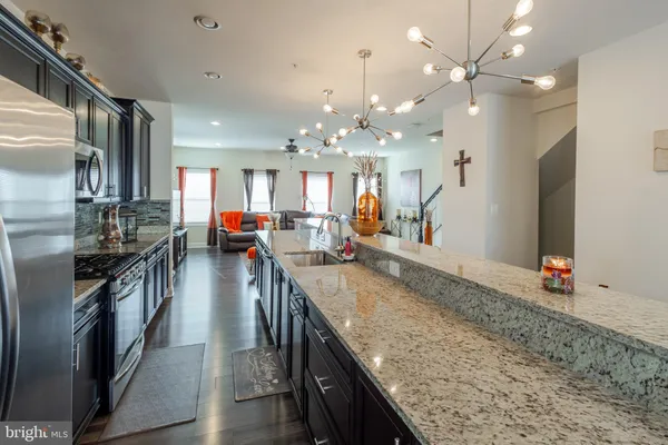 an open kitchen with lots of counter space and refrigerator