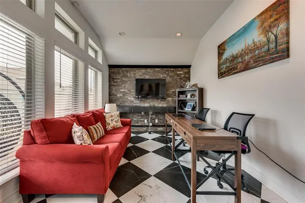 a living room with furniture a large window and a fireplace