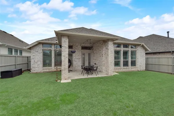a front view of a house with a garden and porch