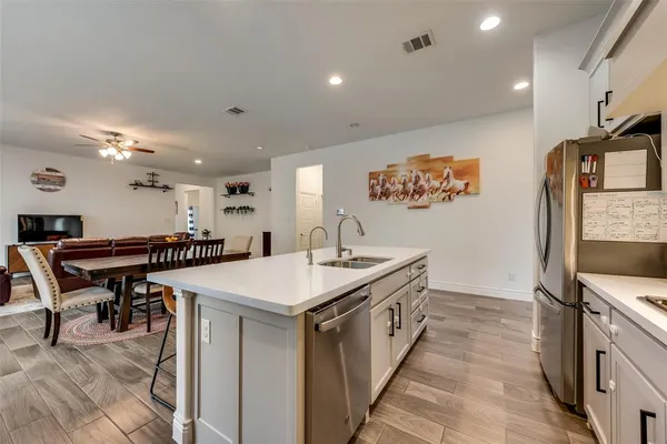 a large kitchen with a table and chairs