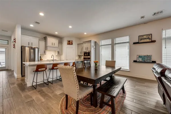 a view of a dining room with furniture and wooden floor