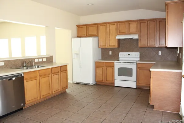 a kitchen with granite countertop cabinets and steel stainless steel appliances