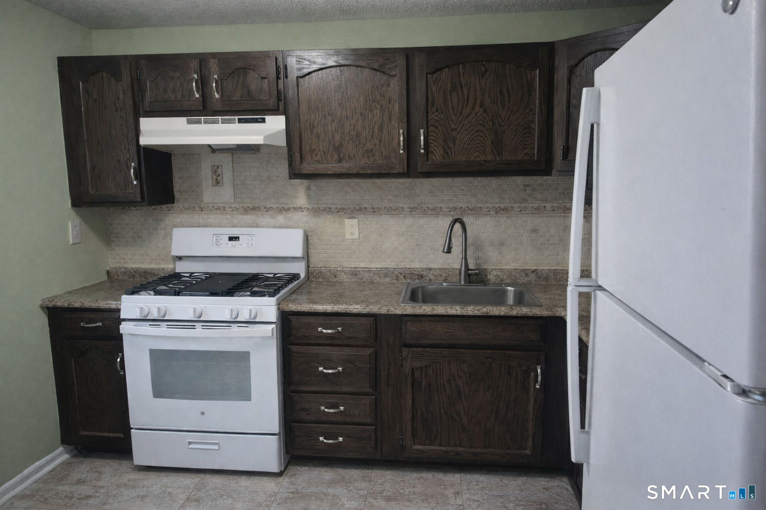 144 East Gate Lane, Unit 144 Hamden, CT 06514 - Photo 13 of 33 a kitchen with a stove sink and cabinets
