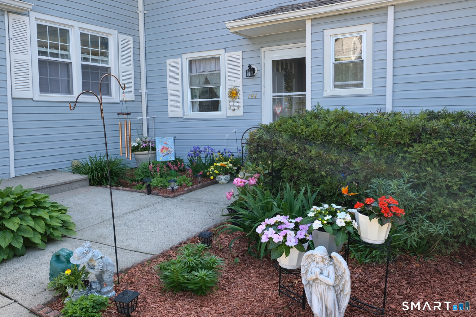 144 East Gate Lane, Unit 144 Hamden, CT 06514 - Photo 5 of 33 a view of a potted plant sitting in front of a house
