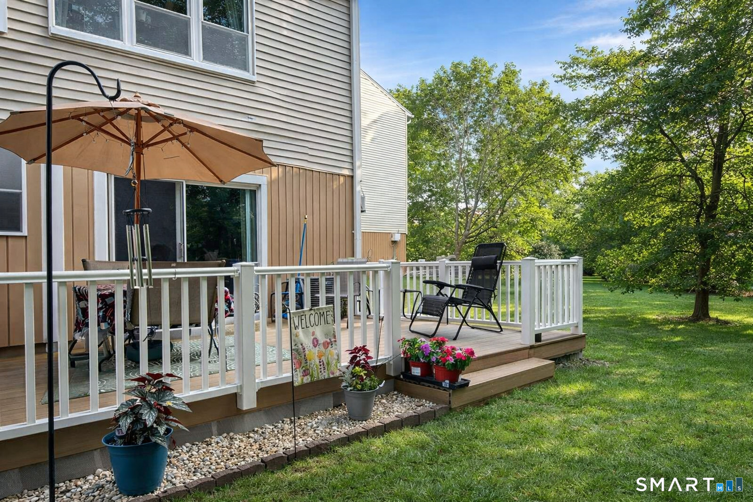 144 East Gate Lane, Unit 144 Hamden, CT 06514 - Photo 7 of 33 a view of a chair and table in backyard of the house