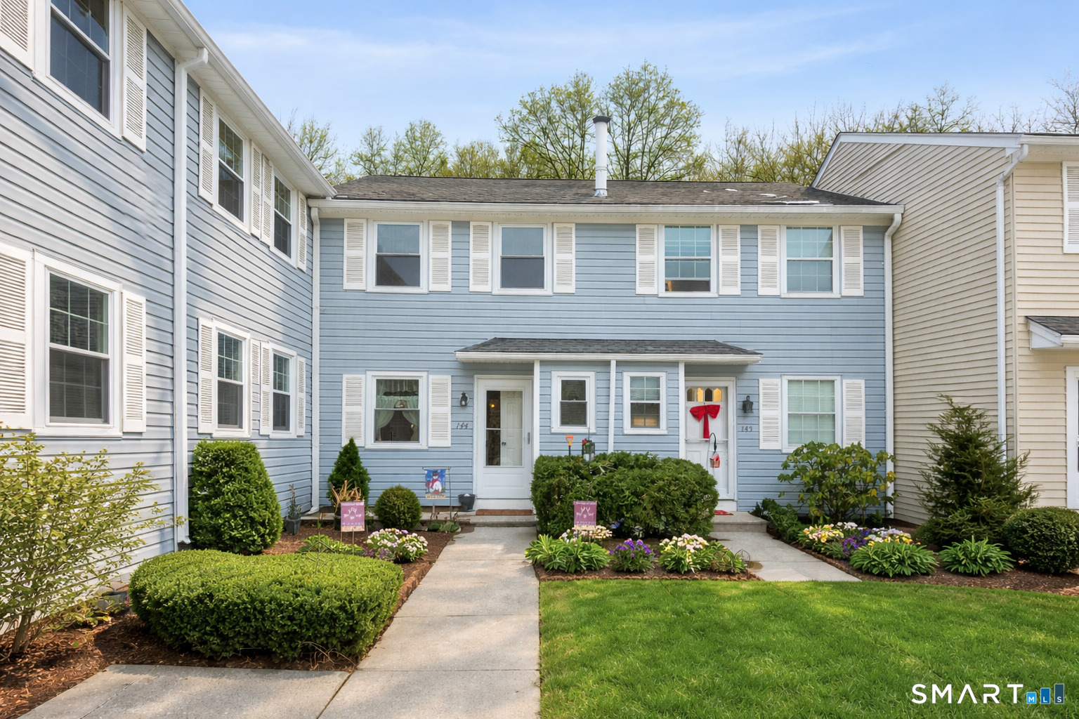 144 East Gate Lane, Unit 144 Hamden, CT 06514 - Photo 9 of 33 a front view of a house with a yard and potted plants