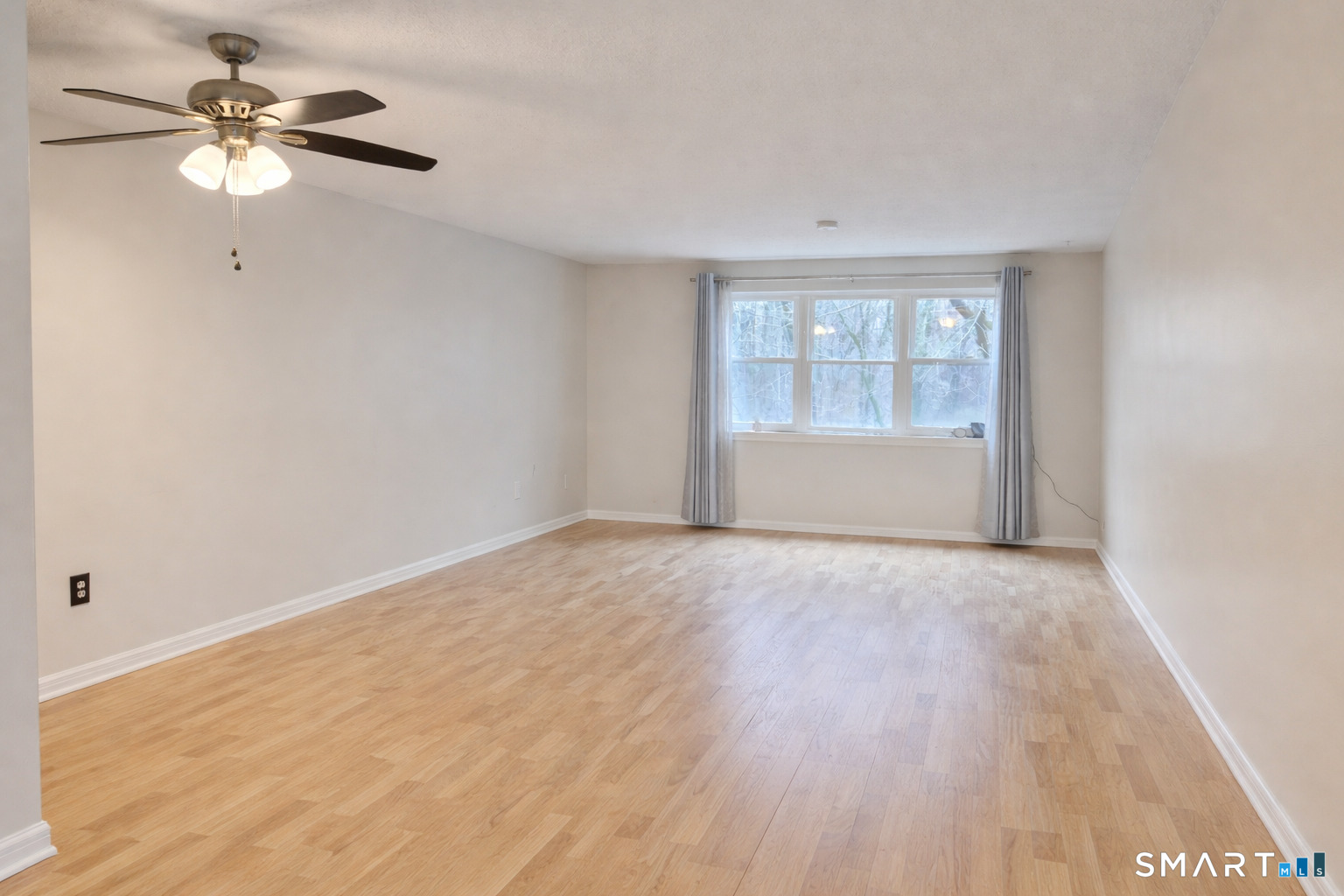 144 East Gate Lane, Unit 144 Hamden, CT 06514 - Photo 10 of 33 wooden floor in an empty room with a window