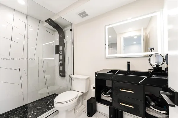 a bathroom with a sink toilet and shower
