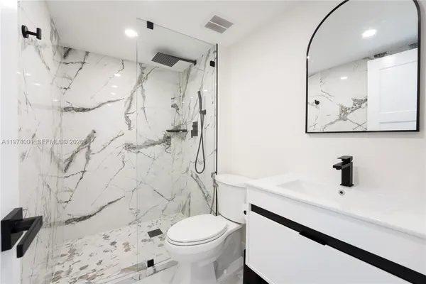 a bathroom with a sink toilet and shower