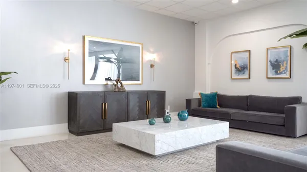 a living room with furniture and painting on the wall