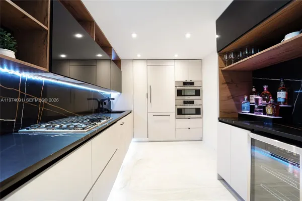 a kitchen with stainless steel appliances a refrigerator and a stove top oven