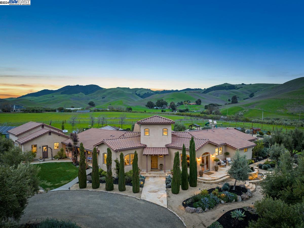 an aerial view of residential houses with outdoor space and mountain view