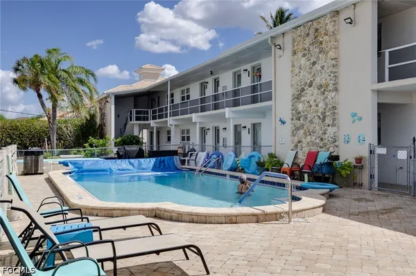 a view of a house with swimming pool and sitting area